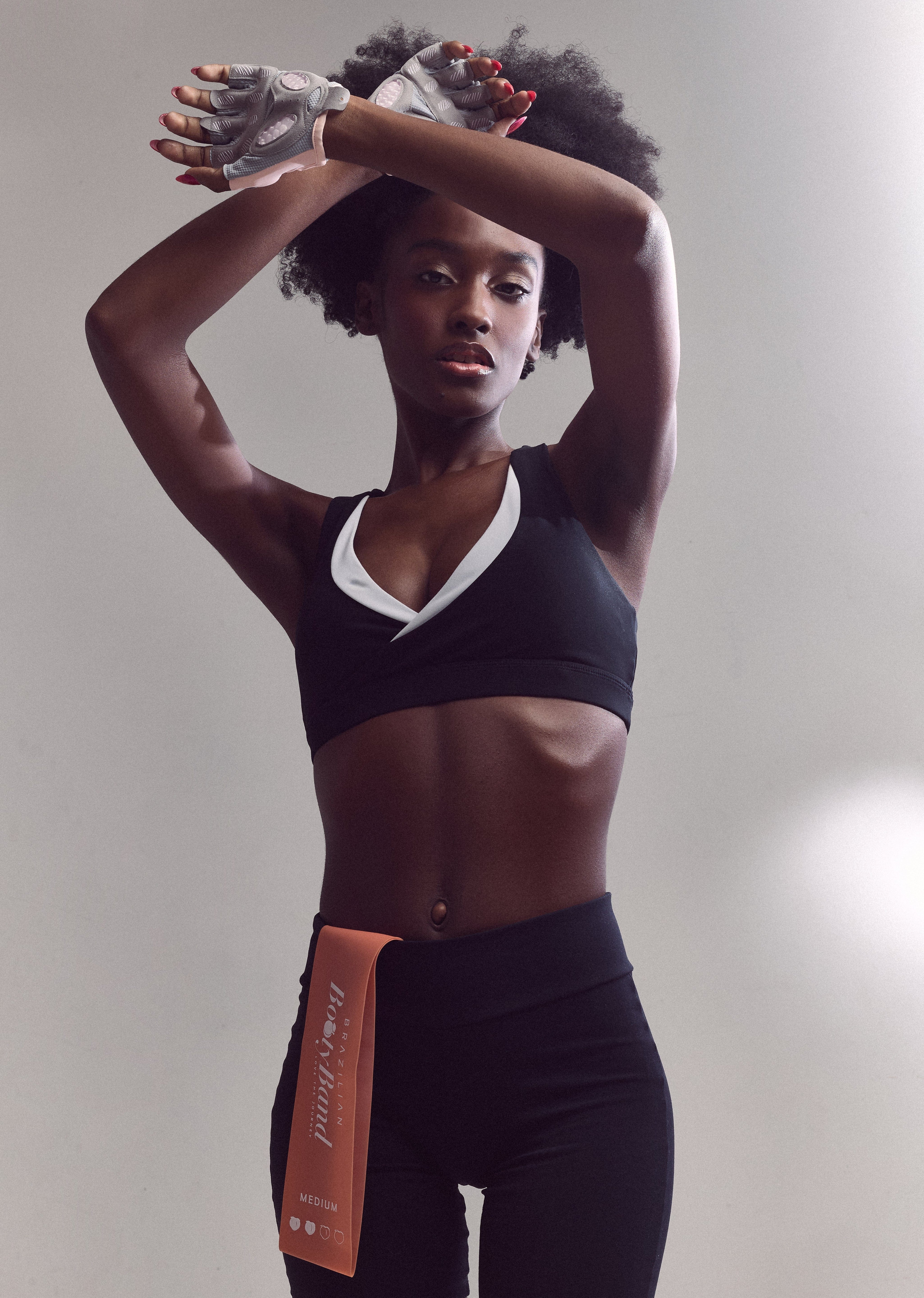 Strong female fitness model in Brazilian Booty Co gym outfit.