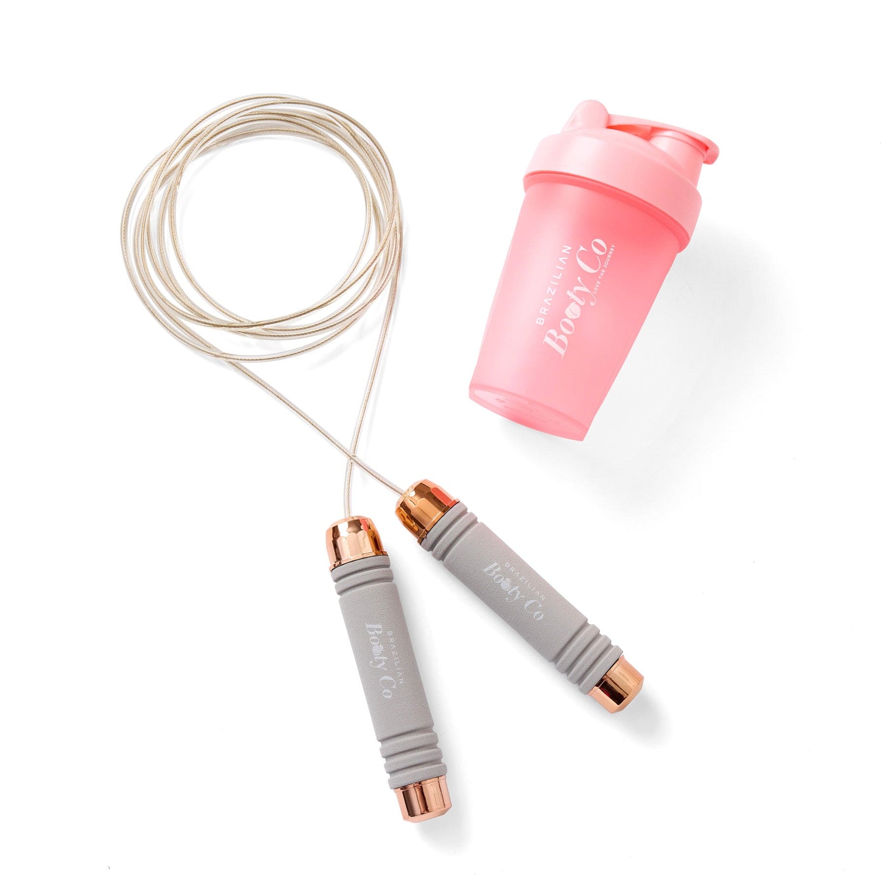 Gray jump rope with rose gold ends and a pink shaker bottle